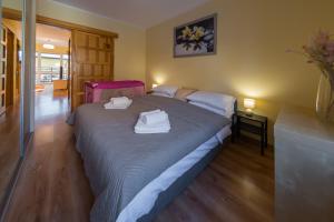 sypialnia z łóżkiem i dwoma białymi ręcznikami na nim w obiekcie Komfortowy Apartament w centrum Ustronia w Ustroniu