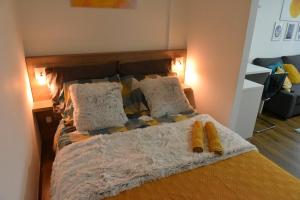 a bed with two pillows on top of it at Central Apartment in Ćuprija