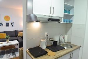 a small kitchen with a sink and a counter top at Central Apartment in Ćuprija +13 photos