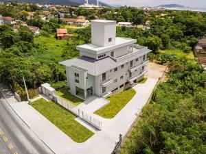 an aerial view of a white building with a tower at Parador Campeche in Florianópolis