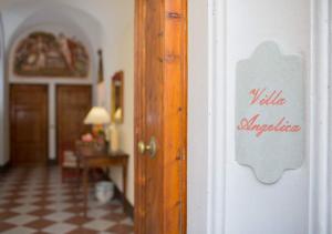 a sign on a door in a room at Villa Il Borgo by MC Luxury Rentals in Montelopio