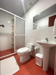 a bathroom with a toilet and a sink at Apartahotel Caribe Diez in San Andrés +41 photos