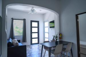 a living room with a table and chairs and a ceiling fan at La Ferreteria Apartments in San Juan