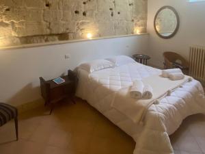 a bedroom with a bed with towels on it at Le Case Nuove Room in Matera