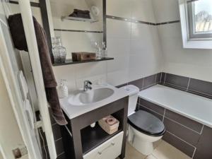 a small bathroom with a sink and a toilet at La Plume - Hypercentre - Place Plumereau in Tours