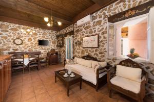 a living room with a couch and a table at Agallis Corfu Residence in Sokrákion