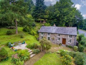 an aerial view of a stone house with a garden at Rock Cottage in Llanfyllin
