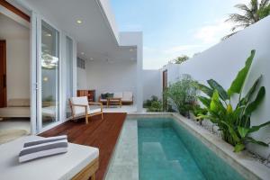 a swimming pool in the backyard of a house at Adults Only Luxury Villa-Gym&Recovery Access in Kuta Lombok