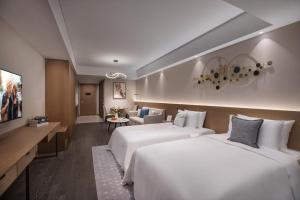 מיטה או מיטות בחדר ב-Citadines New District Wuxi