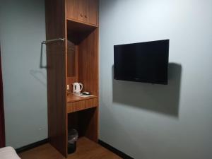 A television and/or entertainment centre at AMBASSADOR LABUAN VIEW HOTEL