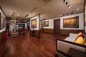 a large room with paintings on the walls and a couch at Heritage Cruises Binh Chuan Cat Ba Archipelago in Ha Long