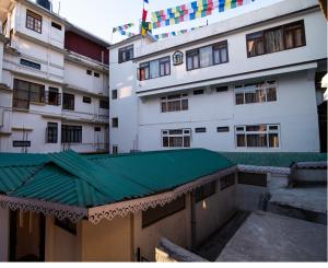 a building with a green roof in front of it at Hotel Shambhala in Gangtok