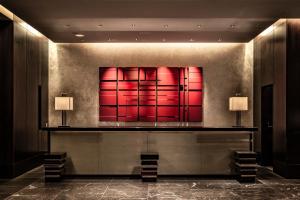 a lobby with a red painting on the wall at The Royal Park Hotel Kyoto Sanjo in Kyoto