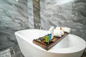 a bathroom with a bath tub with a tray on it at OCEAN HOTEL in Phnom Penh +83 photos