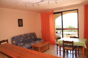 a living room with a couch and a table at 4 people apartment 350 m from the sea in Casaglione