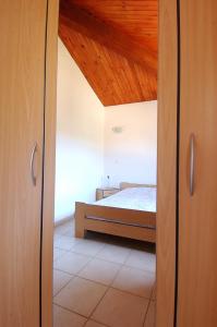a bedroom with a bed and a wooden ceiling at 4 people apartment 350 m from the sea in Casaglione