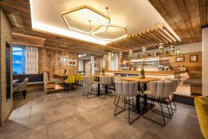 a restaurant with tables and chairs and a bar at Appartement Tauernblick Radstadt in Radstadt