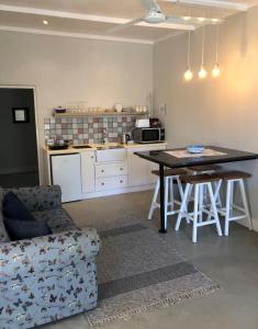 a kitchen and living room with a table and a couch at The Lemon Tree in Prince Albert