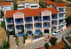 a hotel room with a large white building behind it at Olive Bay Hotel in Agia Effimia