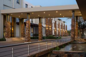 a view of the front of a building with a bridge at Premier Hotel Midrand in Midrand