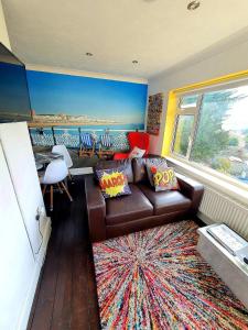 a living room with a couch and a view of the ocean at 3 Bed House Stunning Views And Free Parking in Rottingdean
