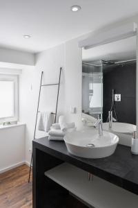 a bathroom with a sink and a large mirror at Casa D‘Antino in Titisee-Neustadt