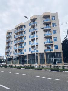 a large apartment building on the side of a street at Hotel Horizont! in Batumi