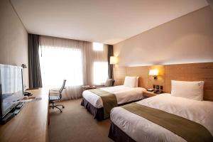 Postel nebo postele na pokoji v ubytování Holiday Inn Gwangju, an IHG Hotel