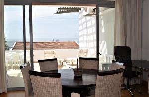 a dining room with a table and chairs at The Square 10 in Plettenberg Bay