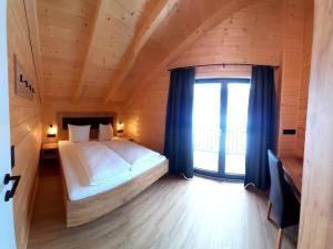 Posteľ alebo postele v izbe v ubytovaní Alpenchalets Nassfeld