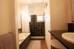 a bathroom with a bath tub and a sink at Sanctuary in Dullstroom +26 photos