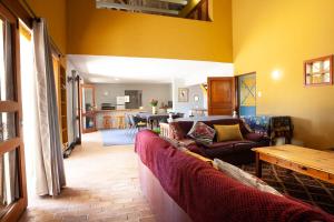 a living room with two couches and a dining room at Sanctuary in Dullstroom