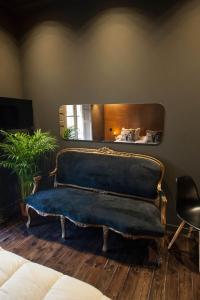 a blue couch in a room with a mirror at Urban Suite Santander in Santander
