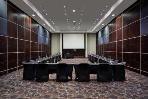 a large room with tables and chairs in it at Premier Hotel O.R. Tambo in Kempton Park