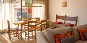 - un salon avec un canapé, une table et des chaises dans l'établissement La Alberca Casa con jardín y piscina, à Tenzuela