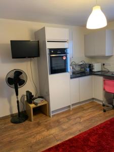 a kitchen with a refrigerator and a stove top oven at Haggai COMFORT SUITES in Parkside