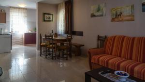 a living room with a couch and a table at Apartment Kremžar Lokve in Lokve