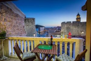a table and chairs on a balcony with a view at Apartment Nera in Dubrovnik