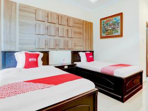 OYO 1762 Hotel Astiti Graha Tanah Lot tesisinde bir odada yatak veya yataklar