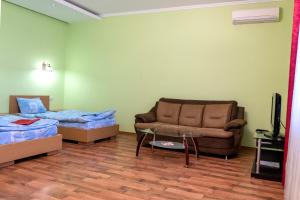 a room with a couch and a bed and a table at Zakarpatskiy Oazis in Karpaty