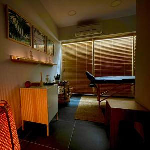 a living room with a table and a desk in it at Athenian Riviera Hotel& Suites in Athens