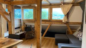 a living room with a couch and some windows at Beautiful apartment in Chamonix centre with superb mountain views in Chamonix-Mont-Blanc