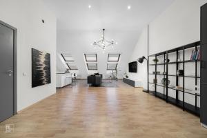 a large room with white walls and a wooden floor at Kaunas Old Town apartment with underground parking in Kaunas