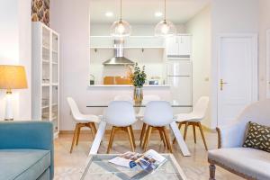Una sala de estar con mesa de comedor y sillas. en Genteel Home Arfe Terrace, en Sevilla