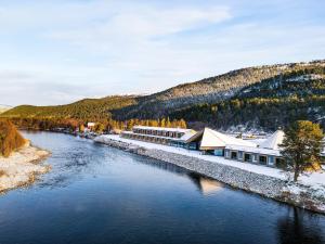 arial view of a river with a resort at Sorrisniva Arctic Wilderness Lodge in Alta