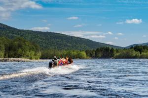a group of people in a boat on a lake at Sorrisniva Arctic Wilderness Lodge in Alta