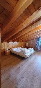 a bed in a room with a wooden ceiling at Mont Bijou MOUNTAIN & QUIET chalet 10 pers by Alpvision Résidences in Veysonnaz