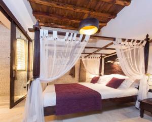 a bedroom with a canopy bed with curtains at Can Ribas Ibiza in Sant Llorenç de Balafia +44 photos