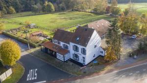 an overhead view of a large white house on a street at B&B De Kroonhoeve in Beringen