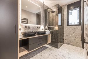 a bathroom with two sinks and a shower at Perfect Lodgings Panorama in Hart im Zillertal +34 photos